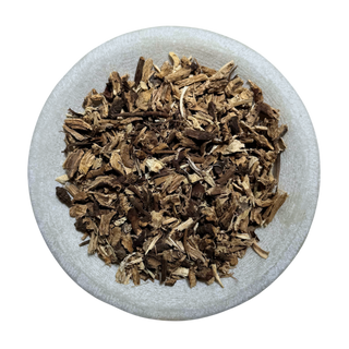 Dried echinacea root in a stone bowl on a white background
