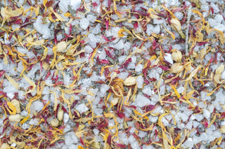 Close-up of floral bath salts on a white background. Botanical boost.