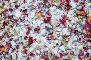 Colorful floral bath salts on a white background. Rest and restore.