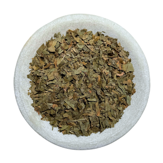 Dried Ginkgo leaf in a white bowl on a white background