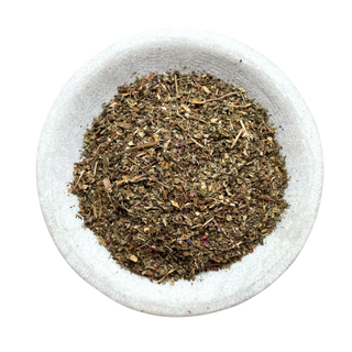 Dried herb robert in a white bowl on a white background