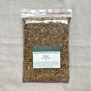 Packaged herb robert with a Wildcraft label on a gray fabric background
