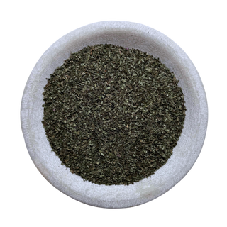 Dried Lemon Balm in a white bowl on a white background