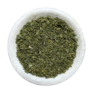 Dried green marshamllow leaf in a white bowl on a white background