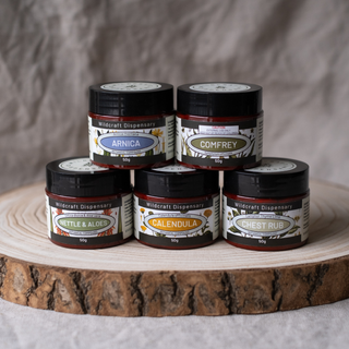 Collection of herbal jars on a wooden surface with a neutral background