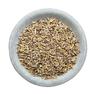 Dried ashwagandha in a stone bowl on a white background