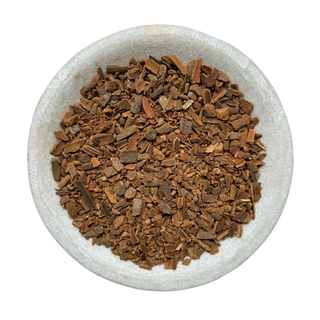 Cinnamon chips in a white bowl on a white background