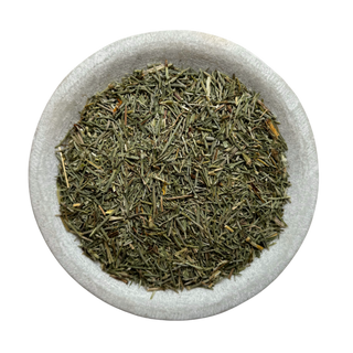 Dried horsetail leaves in a stone bowl on a white background